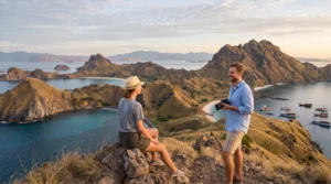 Travelers enjoying the panoramic viewpoint of Padar Island in Komodo National Park at sunrise