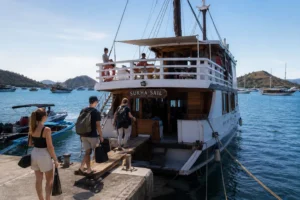 Travelers boarding a Phinisi liveaboard in Labuan Bajo for a Komodo tour