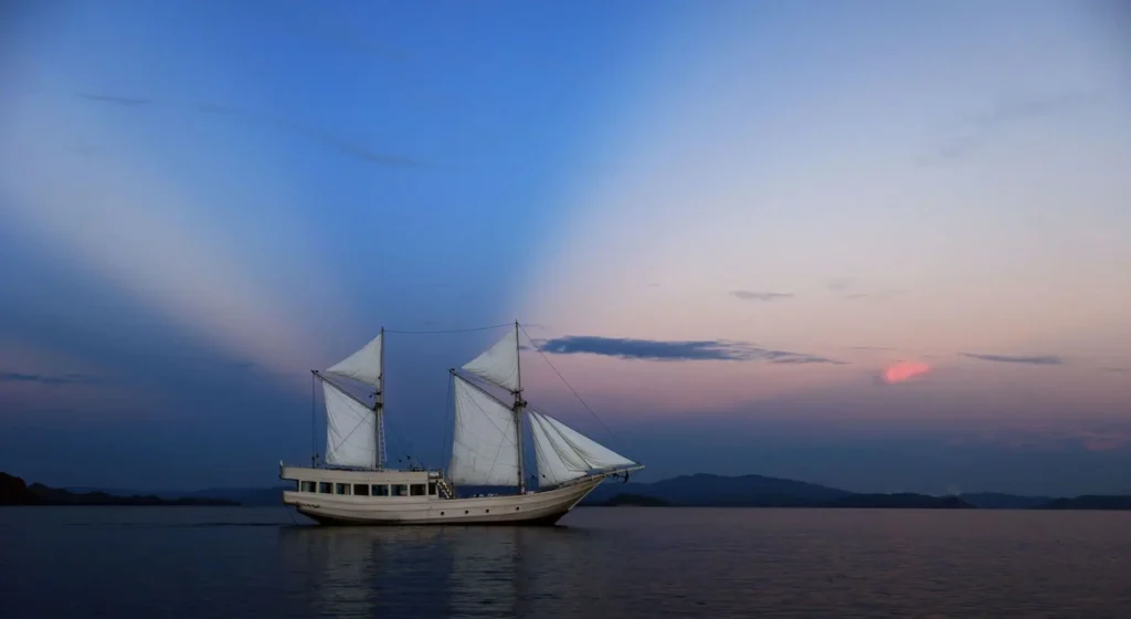 Alexa phinisi viewed from the water at sunset