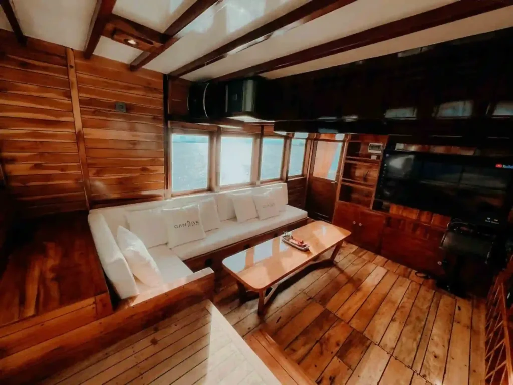 Indoor lounge with sofas aboard Gandiva Phinisi