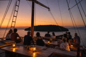 Guests watching the flying fox departure from the deck of a phinisi at Kalong Island