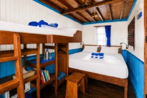 Deluxe cabin aboard Mari with a double bed and sea-view windows