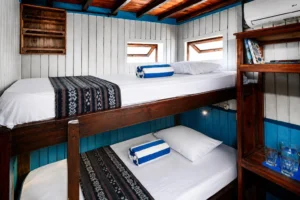 Superior cabin aboard Mari with bunk beds and a sea-view window