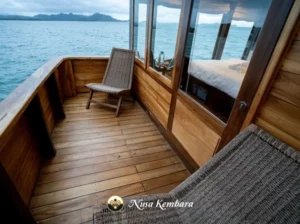 Private outdoor deck beside an upper-deck cabin aboard Nusa Kembara