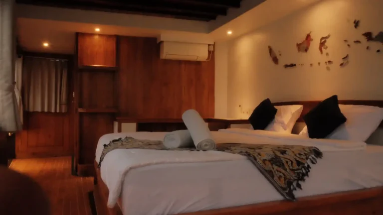 Master Cabin on the upper deck of Panrita with a king bed plus two singles