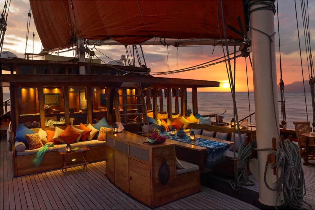 Open-air dining table on the deck of Si Datu Bua