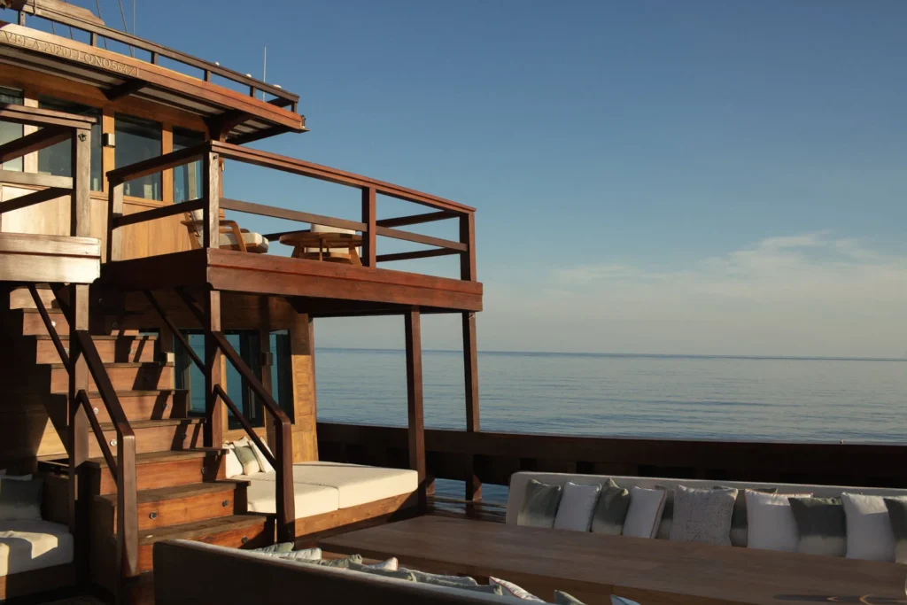 Wide teak terrace and lounge area aboard Vela