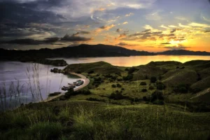 Sunset over the grassy hills and bay of Gili Lawa in Komodo National Park