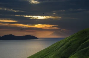 500px provided description: Far away, you can see a smoky cone of Sangeang Api volcano, which last erupted in May 2014 and still looks quite aggresive.