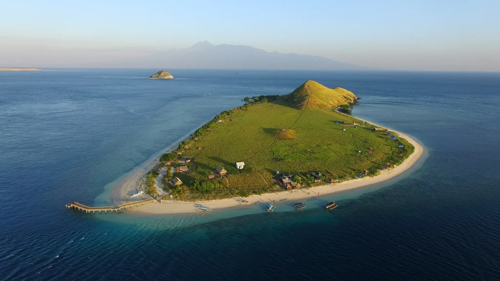 Green savanna and coastline on Kenawa Island.