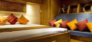 Mantra Phinisi cabin with queen bed and sofa seating