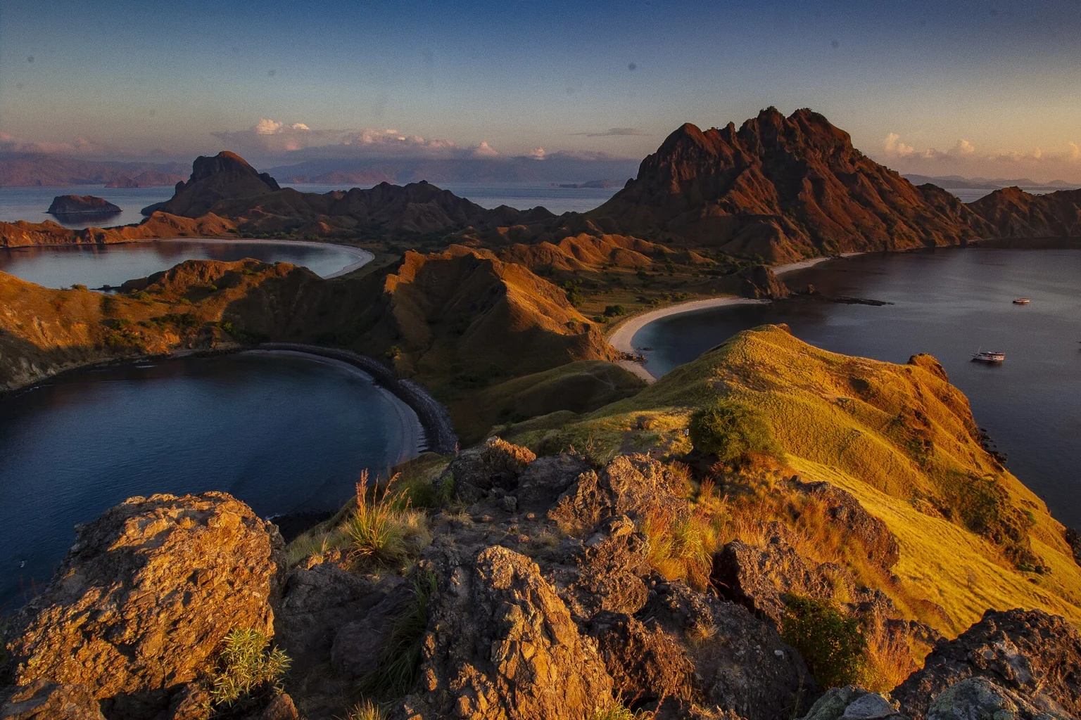 Golden light falls across Padar Island's ridges and bays.