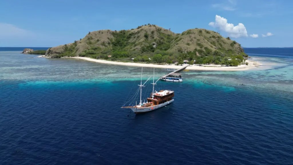 Aerial view of Soe Besar Vanrei anchored near a tropical Komodo island