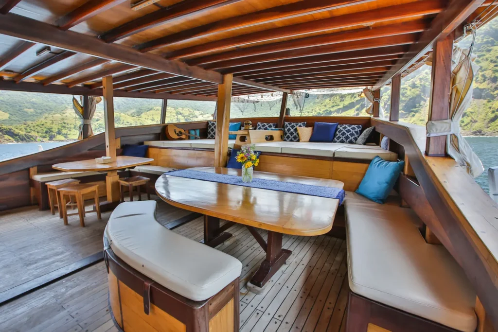Shaded aft lounge and dining area aboard Tanaka Phinisi