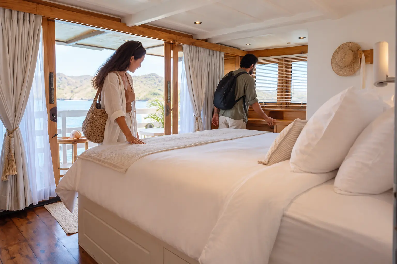Travelers inspect a VVIP phinisi cabin before confirming their Komodo boat booking.